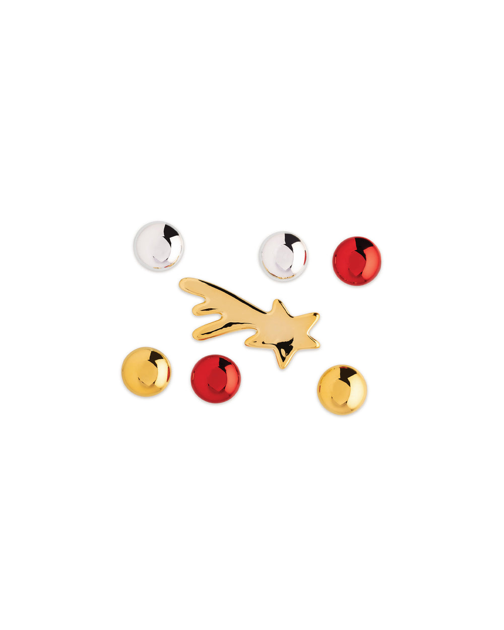 Gold shooting star and round metallic Christmas tree ornaments by Alessi in reflective red, gold, and silver on a white background.