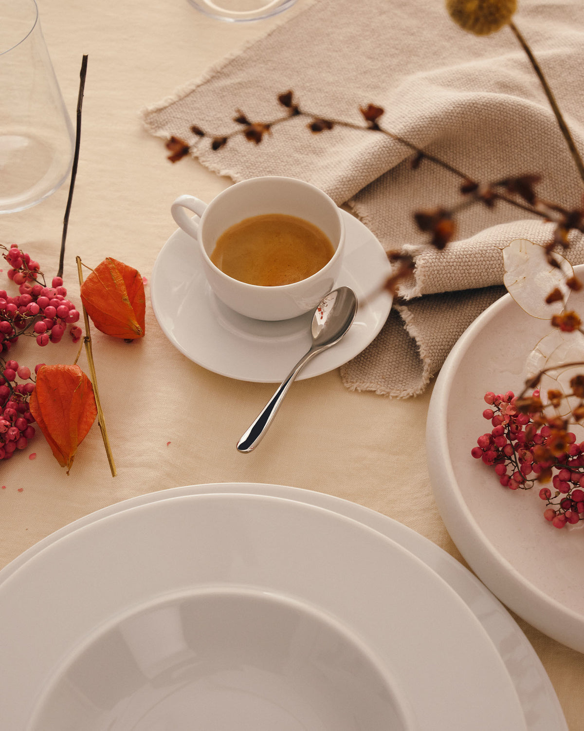 White La Bella Tavola saucers by Alessi, elegantly designed for espresso service on a decorated table.
