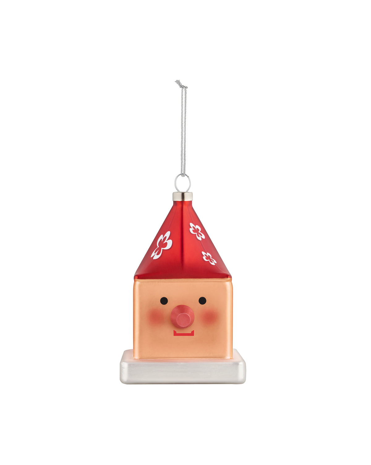 Cubocchio Christmas tree ornament by Alessi, featuring a peach cube body, red pointy roof with white flowers, two black eyes, and a pink nose.