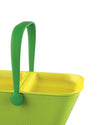 Ribbed green and yellow PetNic travel organizer by Alessi with two interior compartments and a green handle.