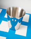 Stainless steel wine cooler by Alessi with a blue and white design and perforated scalloped top edge.