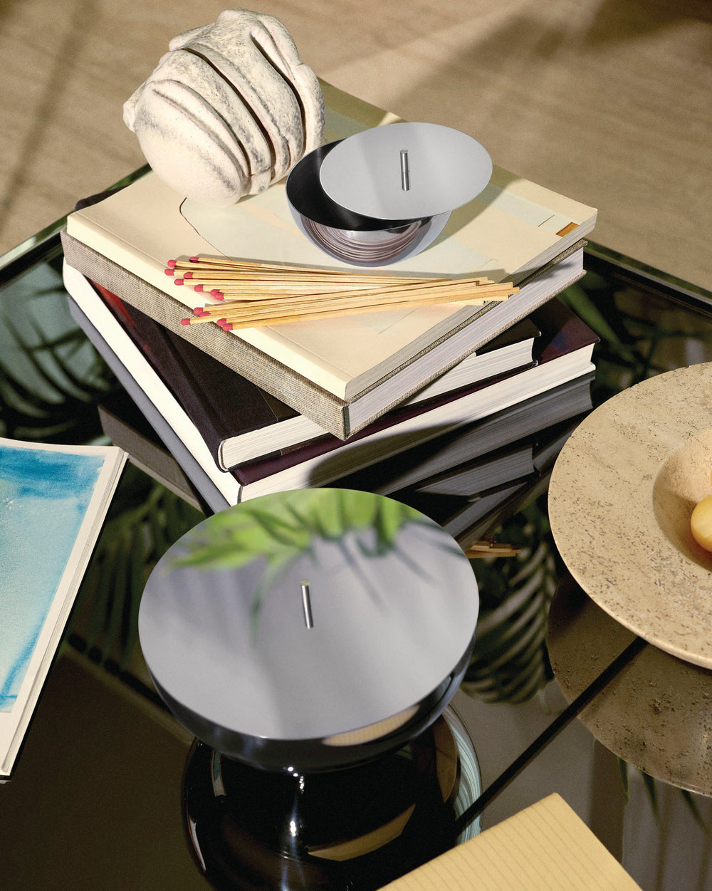 Polished silver Rocc container by Alessi, shown with its flat lid and sleek vertical tab handle.