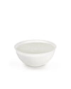 White five-wick candle by Alessi in a wide, shallow white bowl, shown from a slightly elevated angle.