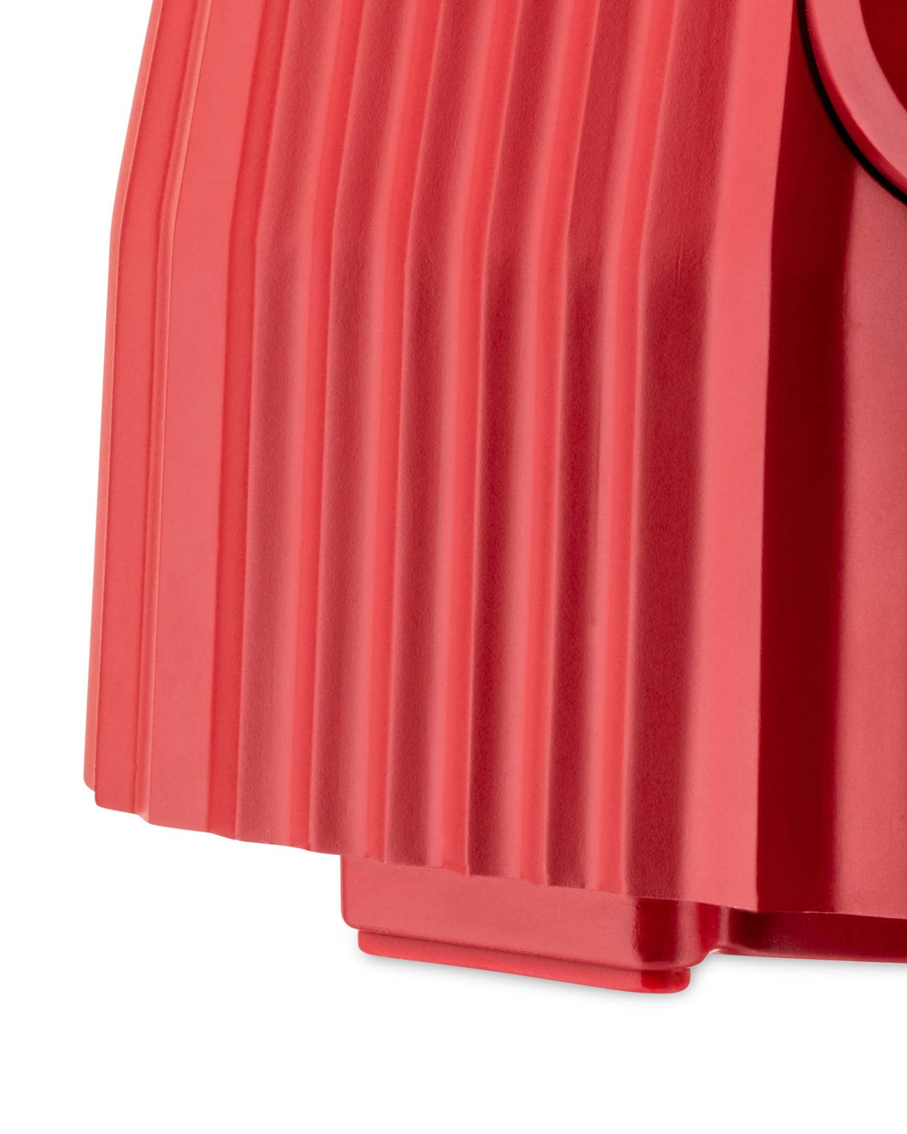 Coral red pleated blender by Alessi with a matte finish, showing the lower section.