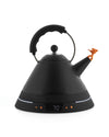 Black electric kettle by Alessi with a conical shape, matte finish, orange bird whistle, and a digital display.