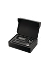 Black pasta gift set by Alessi, open with silver tools: a long spoon, grater, and pasta measure.