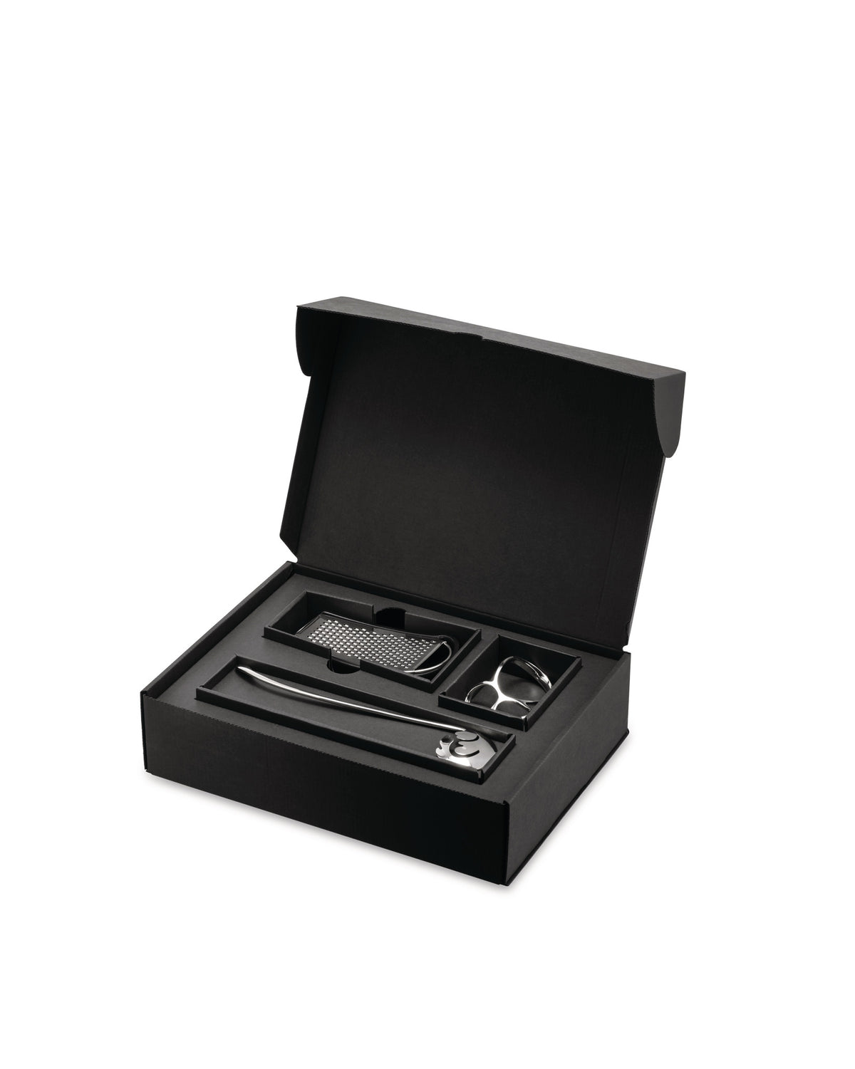 Black pasta gift set by Alessi, open with silver tools: a long spoon, grater, and pasta measure.