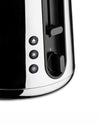 Black and chrome toaster by Alessi with illuminated control buttons for eject, defrost, reheat, and a browning dial.