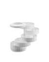 White multi-tiered capsule holder by Alessi, with ribbed sides and a circular, offset design.