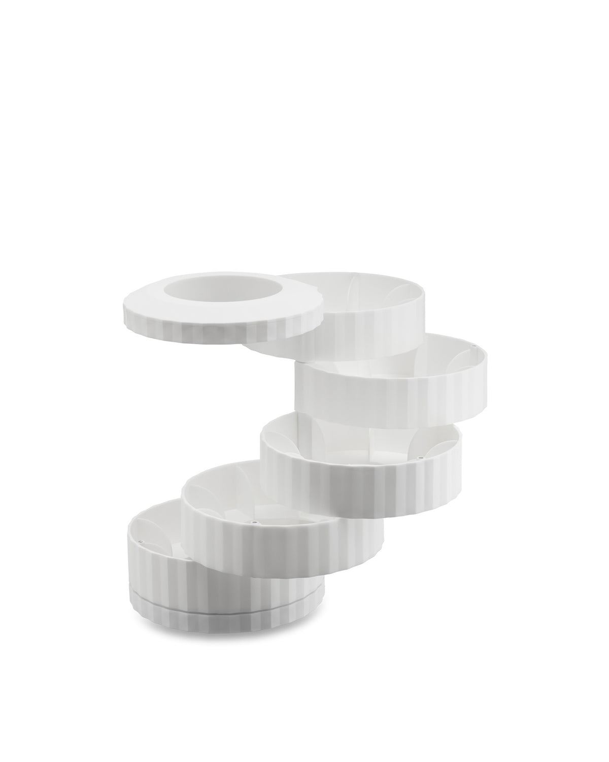White multi-tiered capsule holder by Alessi, with ribbed sides and a circular, offset design.