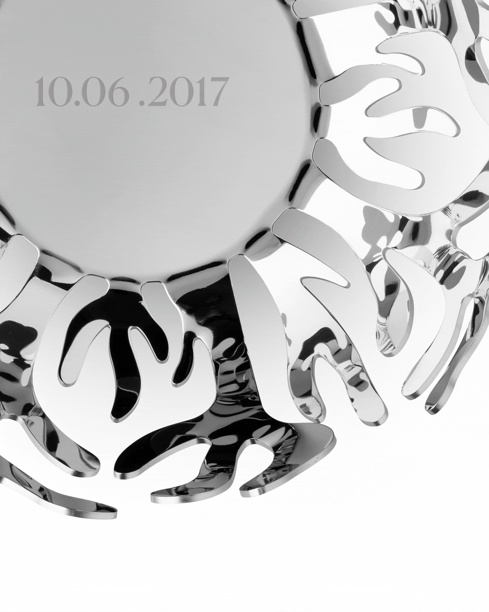 Silver polished metal decorative bowl by Alessi, with an engraved date '10.06.2017' and organic openwork rim.