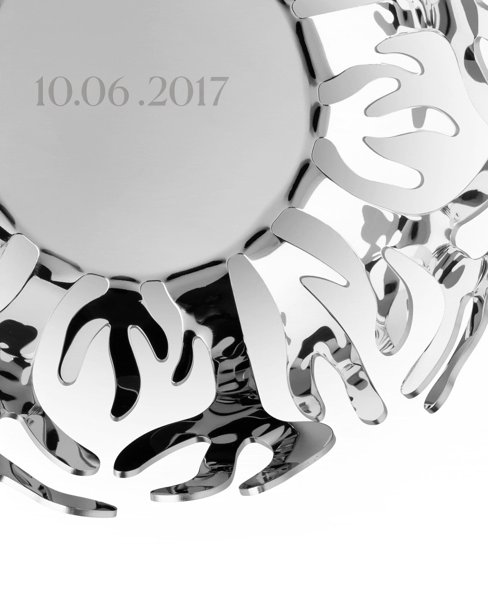Silver polished metal decorative bowl by Alessi, with an engraved date '10.06.2017' and organic openwork rim.
