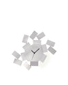 White metal wall clock by Alessi, featuring a deconstructed geometric design with a central hexagonal face.