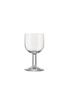 A clear stemmed glass by Alessi, featuring a wide bowl and slender stem on a white background.