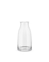 Clear glass pitcher by Alessi with a slightly flared rim and thick, wide base.