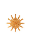 Light brown wooden wall clock by Alessi, featuring radiating slats with Roman numerals, 'XXX' markings, and orange hands.