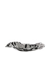 Wavy silver metallic bowl by Alessi with an undulating, highly reflective surface.
