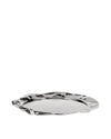 Polished silver metal serving tray by Alessi, with a wavy, crumpled edge and highly reflective surface, viewed at an angle.