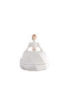 White porcelain decorative box by Alessi, shaped like a bride with golden hair and puff sleeves, seen from the back.