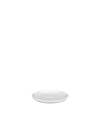 A white saucer by Alessi, angled on a white background, with a subtle indentation.