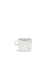 White cup by Alessi with a simple, modern design and handle, casting a shadow.