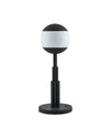 Black and white spherical table lamp by Alessi with a fluted stem and round base.