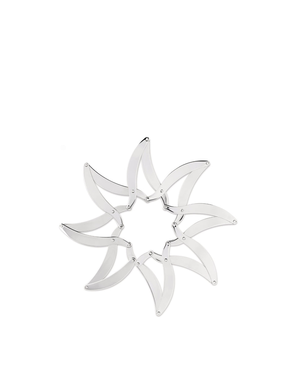 Silver metal trivet by Alessi, composed of multiple curved pieces interconnected in a star shape.
