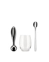 Polished metallic citrus squeezer by Alessi, alongside a clear glass and long stirring spoon.