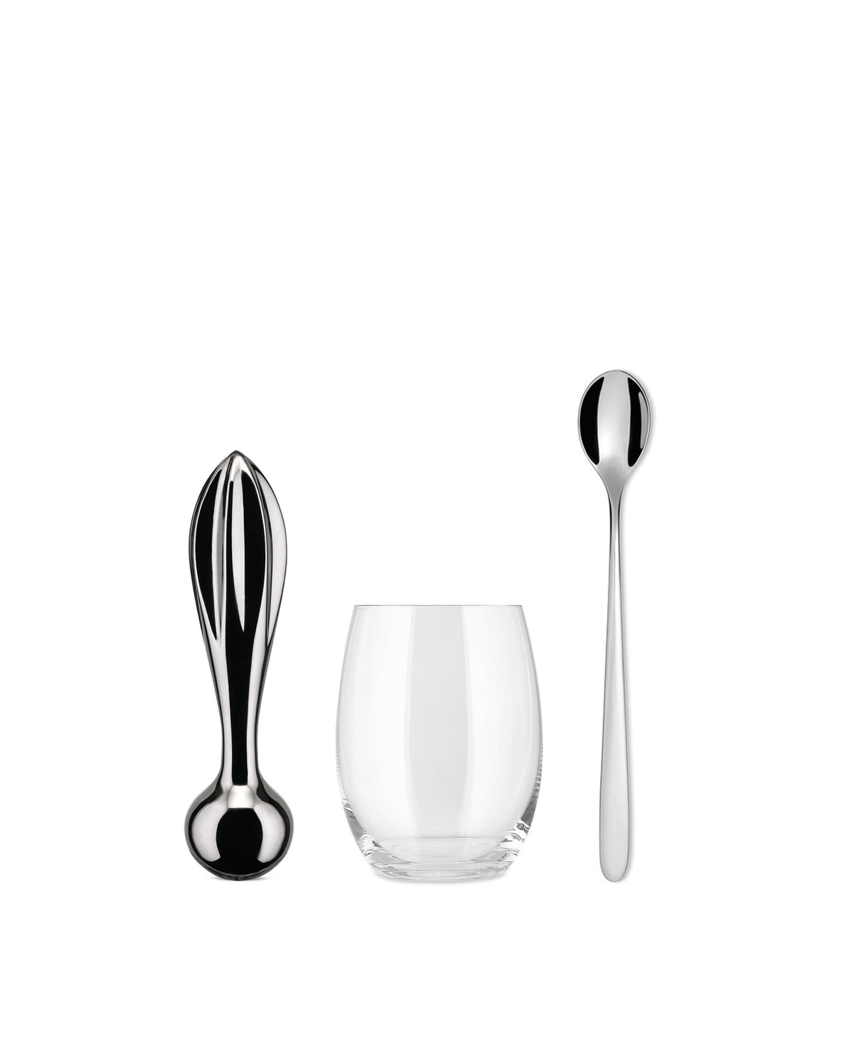 Polished metallic citrus squeezer by Alessi, alongside a clear glass and long stirring spoon.