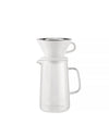 White ceramic and glass slow coffee maker set by Alessi, with a silver-rimmed pour-over cone atop a clear carafe.