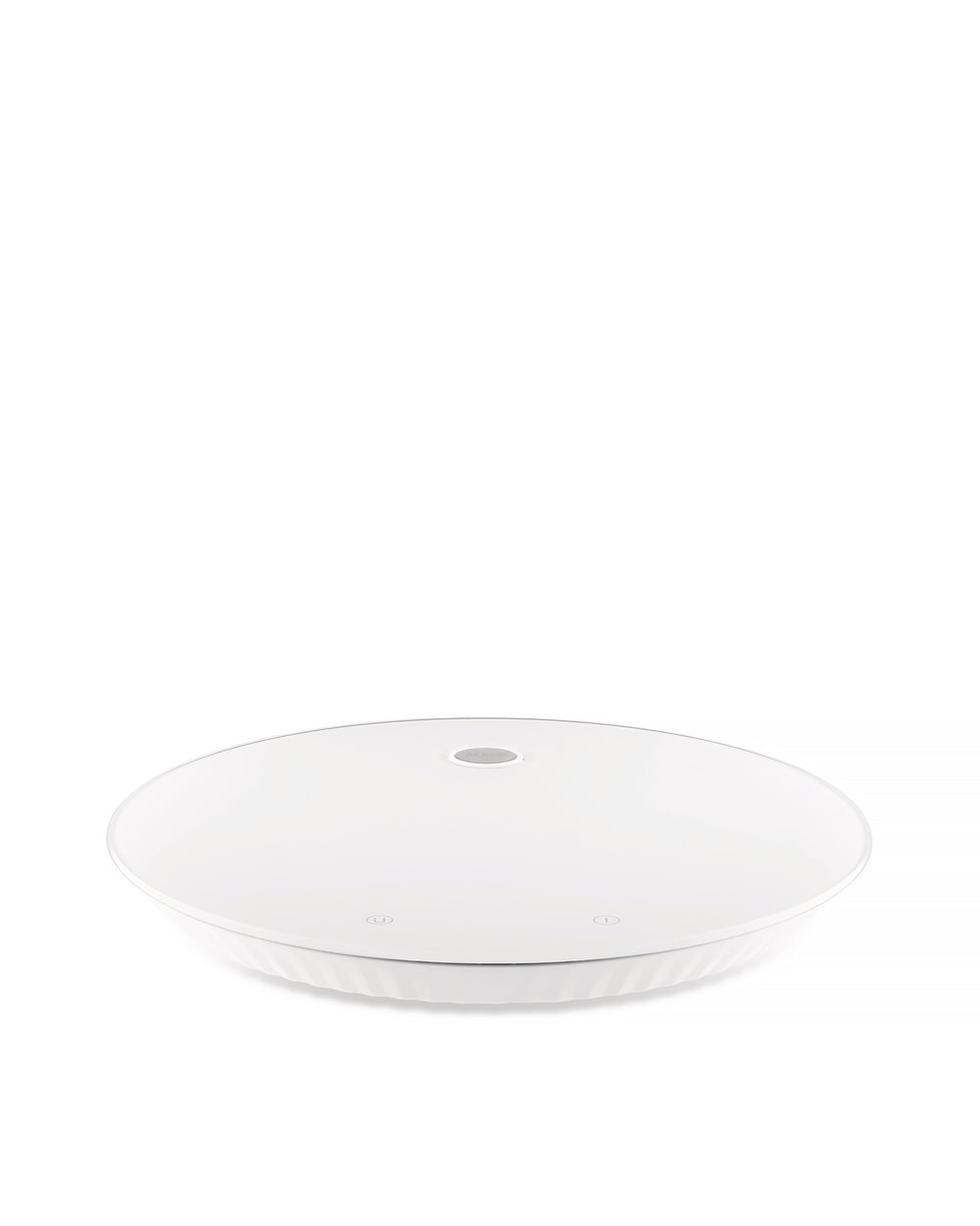 White round kitchen scale by Alessi with a ridged base and two subtle touch controls on the surface.