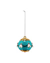 Teal blue decorative ornament by Alessi, a glossy sphere with gold trim and white bees with red eyes.