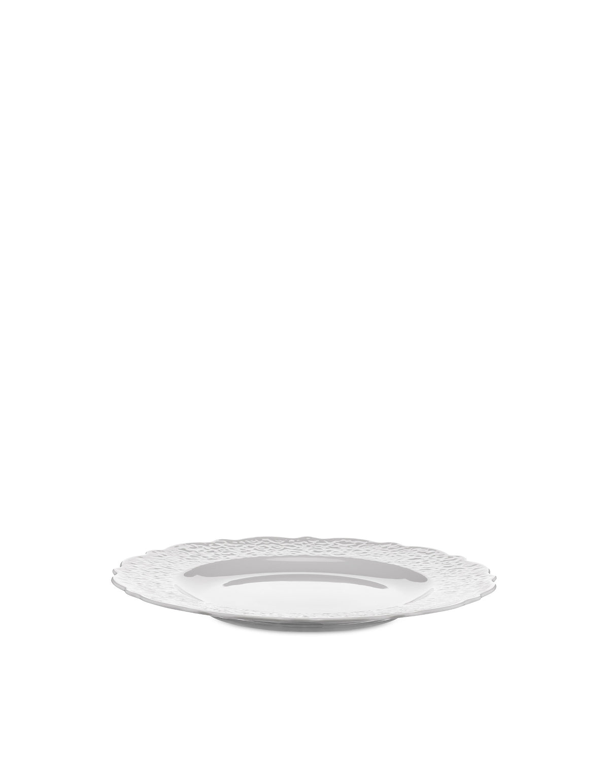White plate by Alessi featuring a decorative, textured wavy rim, presented at a low angle.