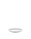 White plate by Alessi with wavy, scalloped edges, angled on a white background.