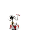 Silver elephant figurine by Alessi, balancing on a golden ball with a red and white striped umbrella and a small mouse on a circus-patterned base.