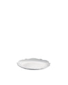 White scalloped plate by Alessi, shown at an angle.