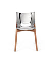 Modern chair with a reflective chrome-like seat and back by Alessi, featuring light wooden legs, front view.
