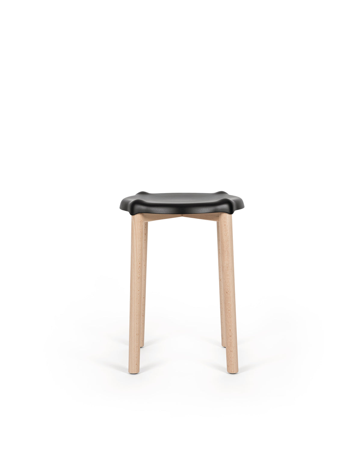 Black-seated stool by Alessi with a distinctive wavy seat and natural light wooden legs on a white background.