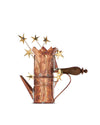A copper coffee maker by Alessi, decorated with golden stars, a heart detail, and a dark wooden handle.