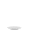 White saucer by Alessi, smooth and round with a central depression for a cup.