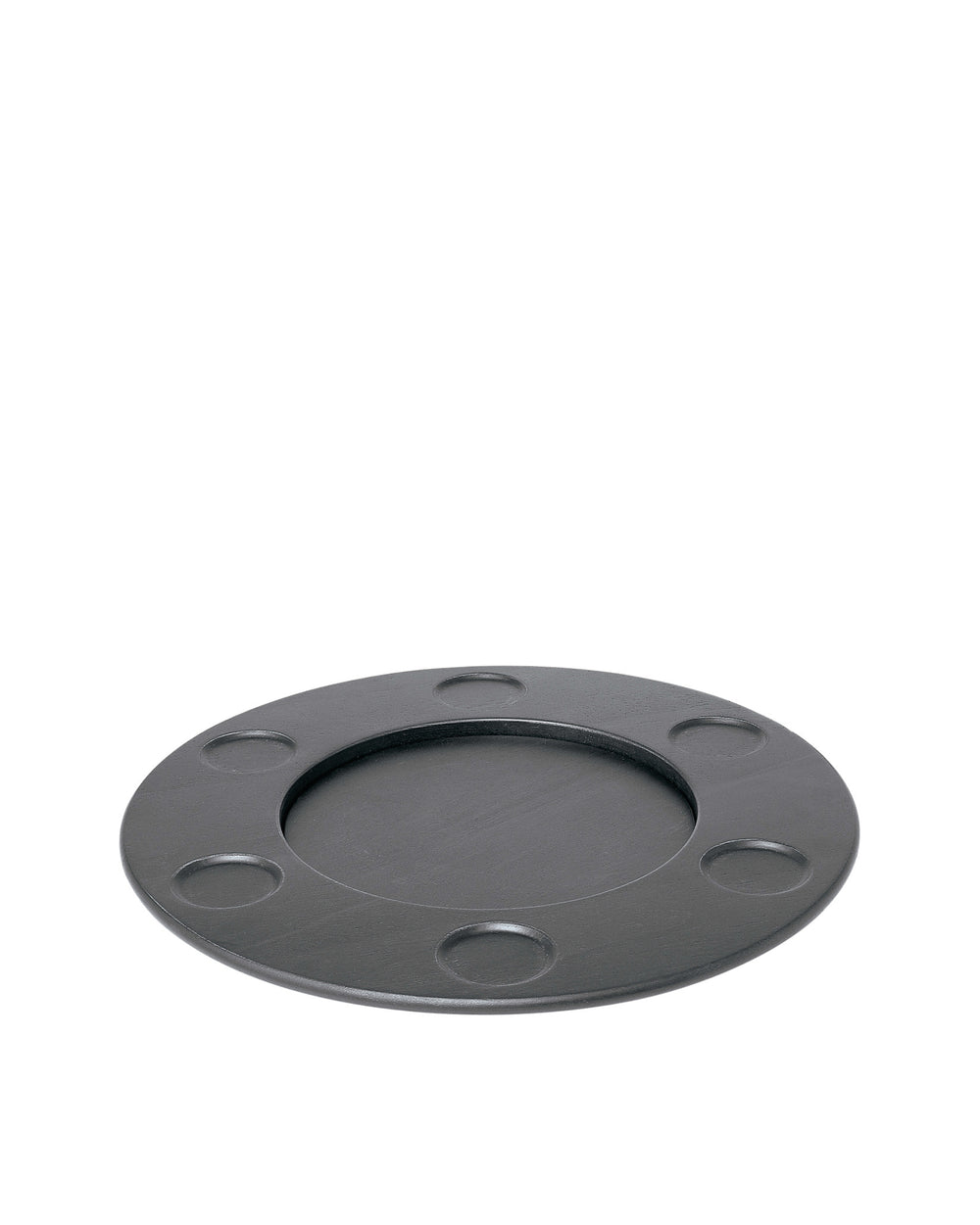 Round matte dark grey trivet by Alessi with a central well and seven smaller circular indentations.