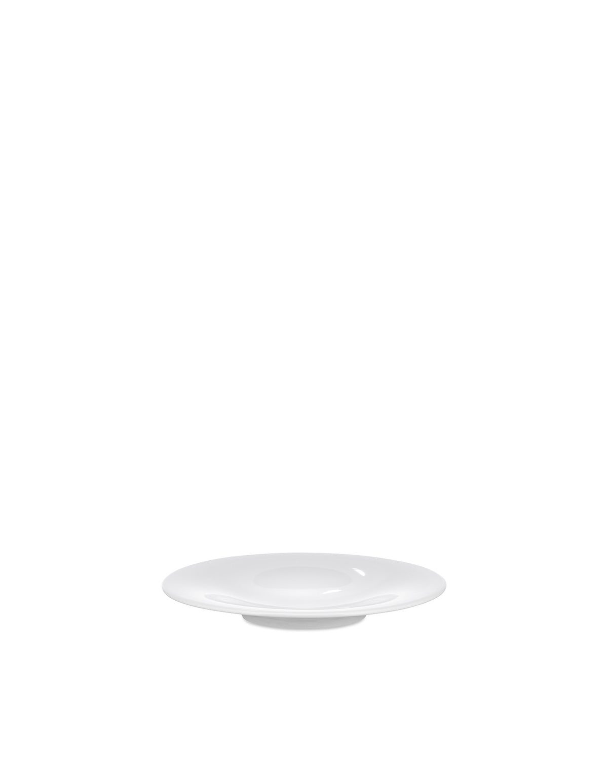 A round white plate by Alessi, shown from a low angle.