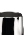 Shiny silver metal creamer by Alessi, cropped top view with dark interior.