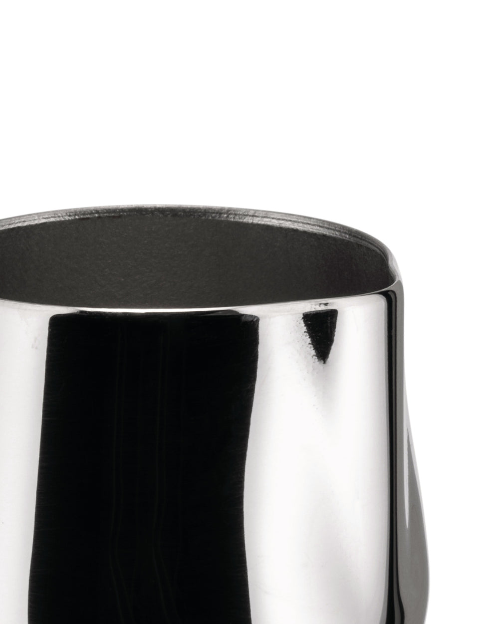 Shiny silver metal creamer by Alessi, cropped top view with dark interior.
