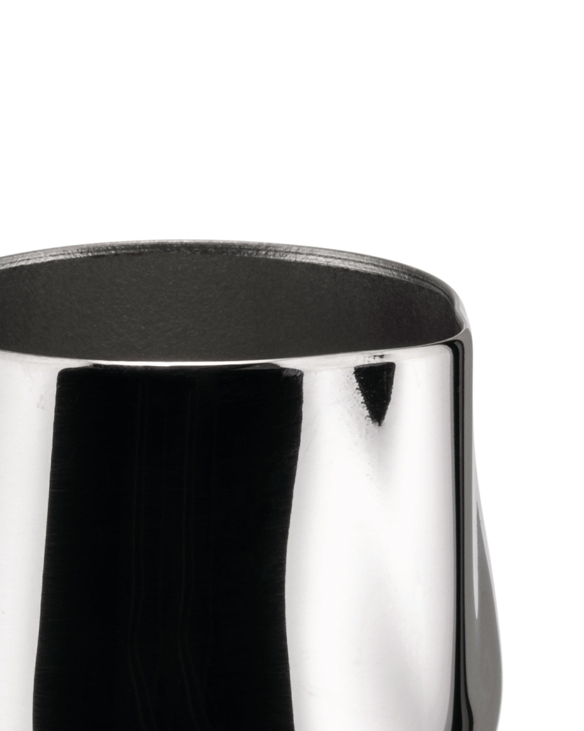 Shiny silver metal creamer by Alessi, cropped top view with dark interior.