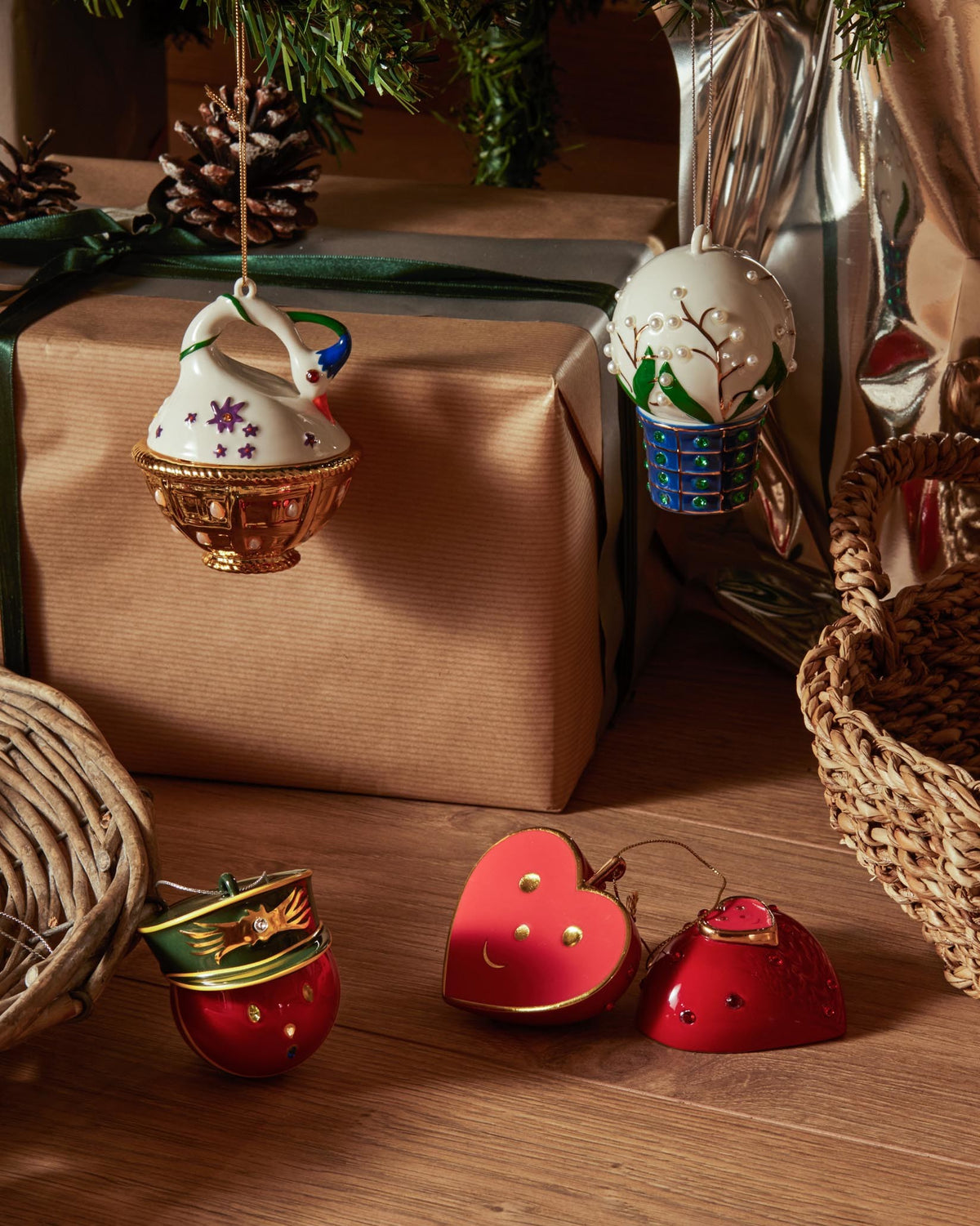 White swan ornament by Alessi, detailed with colorful accents and a golden base, hanging from a Christmas tree.