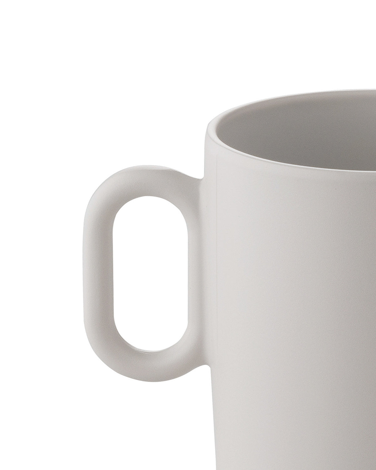 Light grey ceramic mug by Alessi with a smooth matte finish and minimalist handle, cropped.