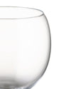 Clear glass Mami XL bowl by Alessi, cropped close-up showing a curved rim and body.
