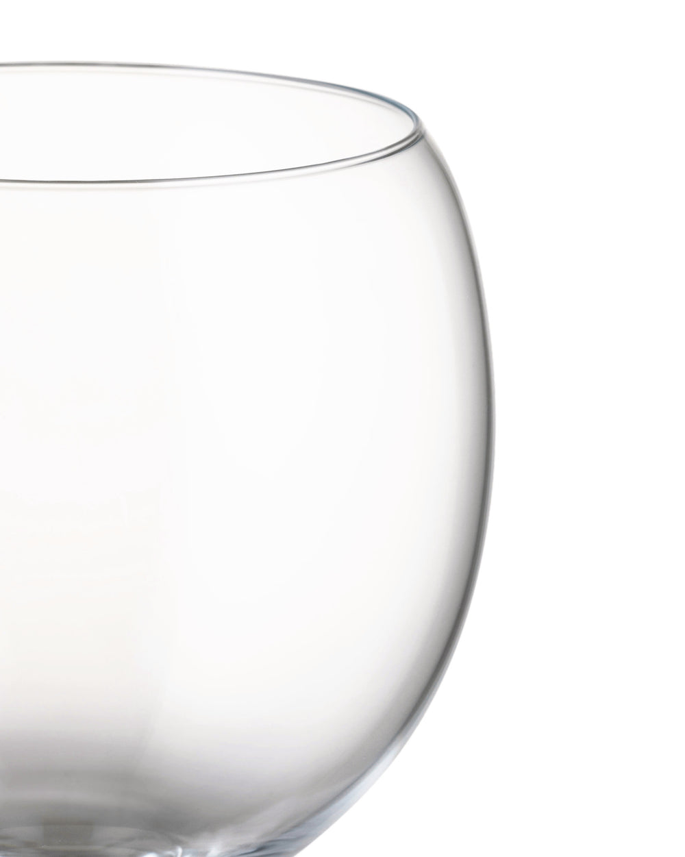 Clear glass Mami XL bowl by Alessi, cropped close-up showing a curved rim and body.