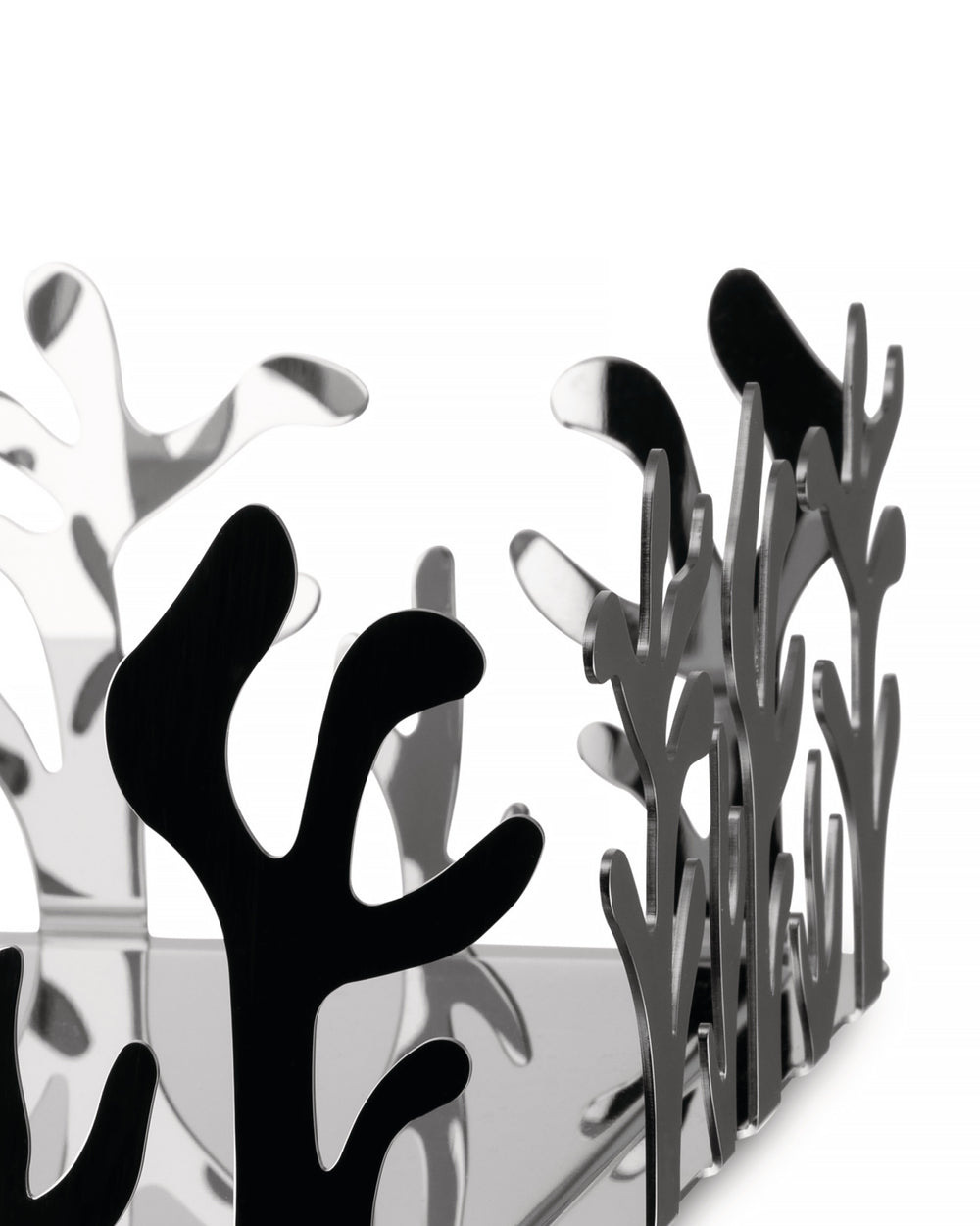 Silver reflective fruit bowl by Alessi featuring an intricate, coral-like cut-out design.